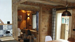 A rustic wooden interior with a dining area, a wooden cabinet with drawers, and a tiled floor. - Chalet with view, in a quiet area, close to all services in summer and winter. (Saint-Gervais-les-Bains)