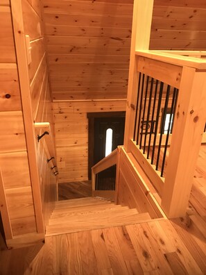 A wooden staircase with a metal railing leading to a door. - Beautiful 3 bed / 3 bath Luxury Cabin, Hot Tub, Games, Easy Check in! Book Now! (Sevierville)