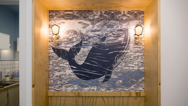 A wooden-framed artwork of a whale's tail in a bathroom. - Il Grande Blu (Terracina)