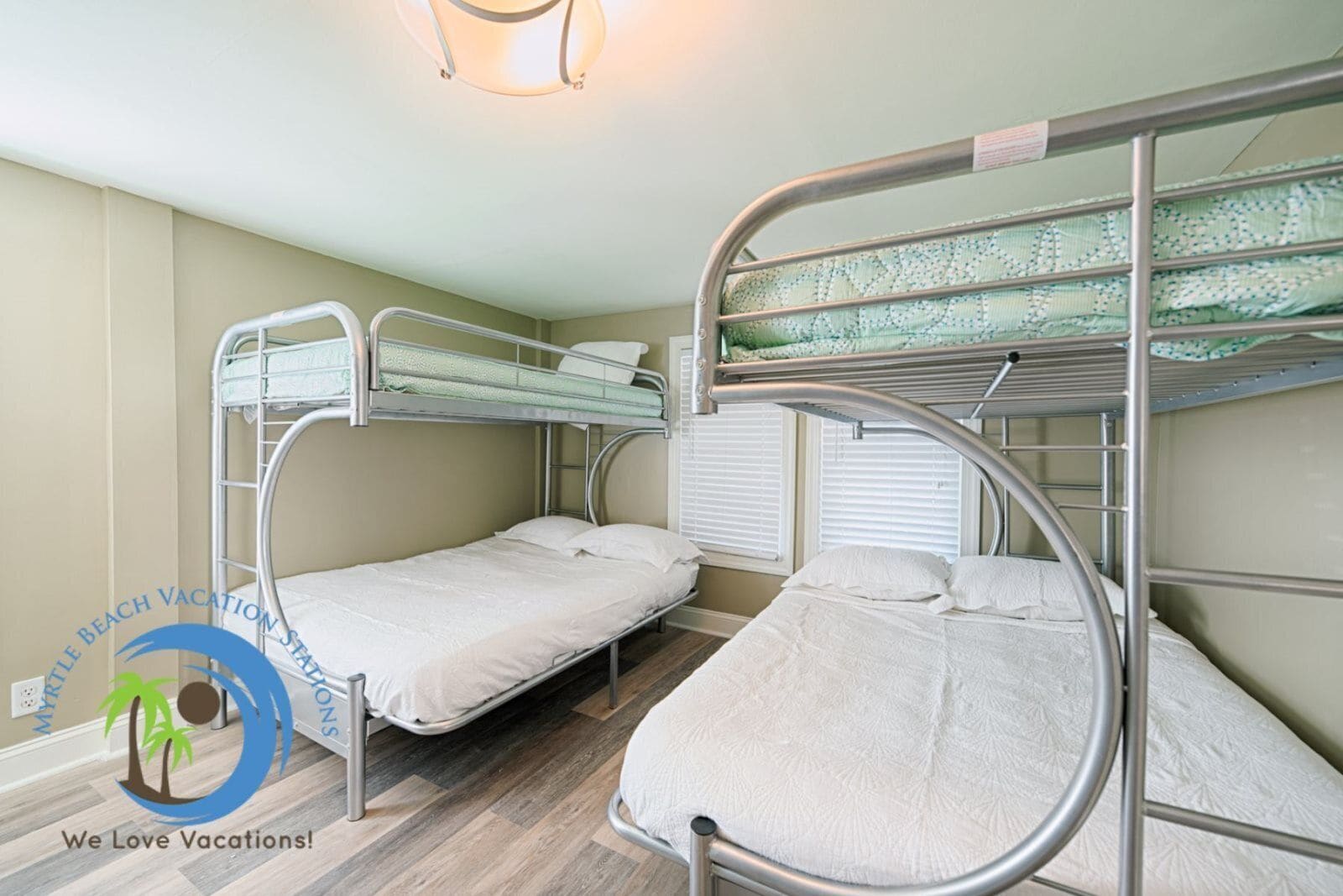 A bunk bed room with a window and a light fixture.
