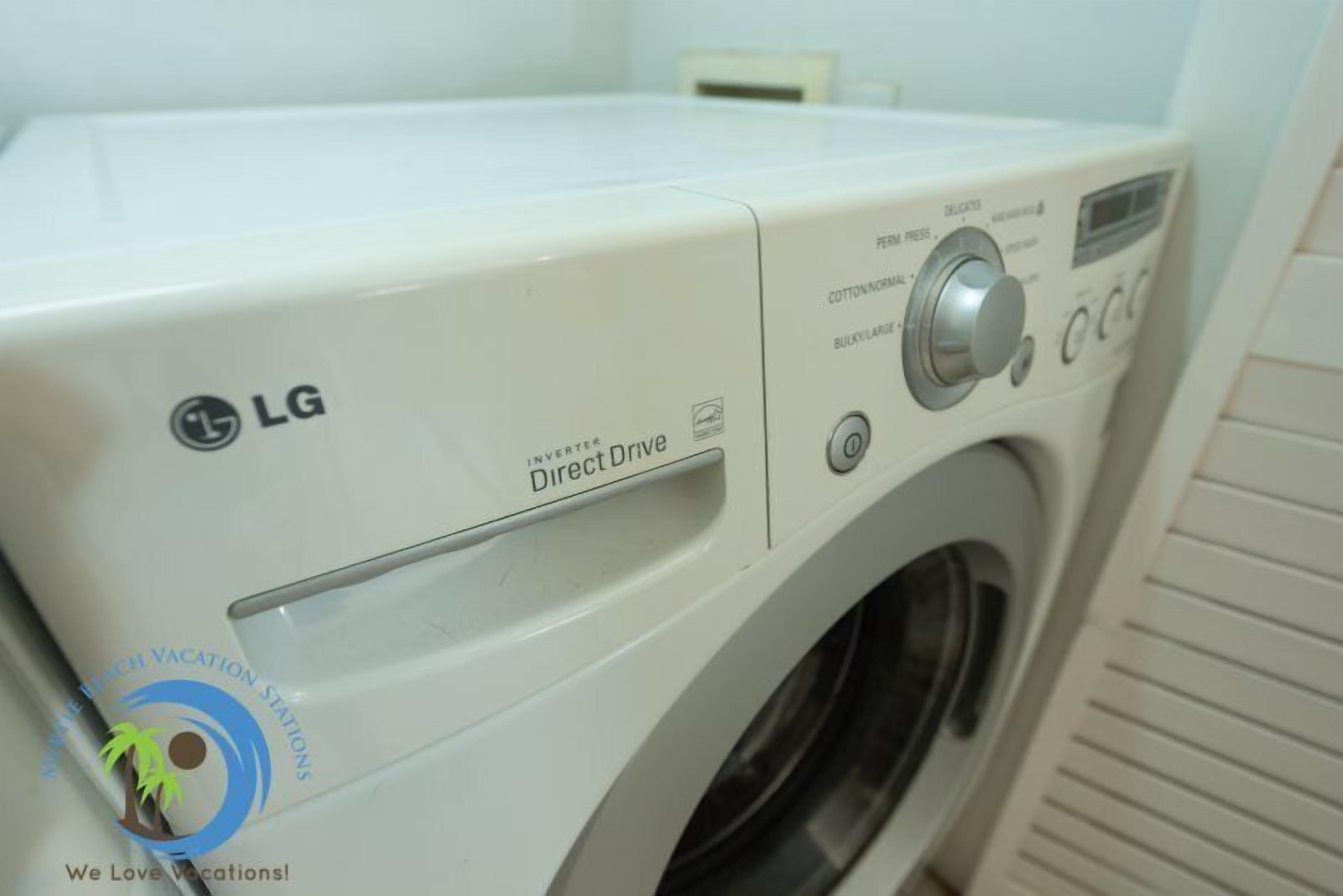 A front view of an LG Direct Drive washing machine in a hotel room.