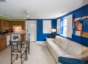 A compact living space with a kitchenette, a dining area, and a seating area with a couch. - Windy Hill Villa A (North Myrtle Beach)