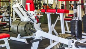 A gym with weightlifting equipment, including a squat rack and benches. - CG Efficiency (North Myrtle Beach)