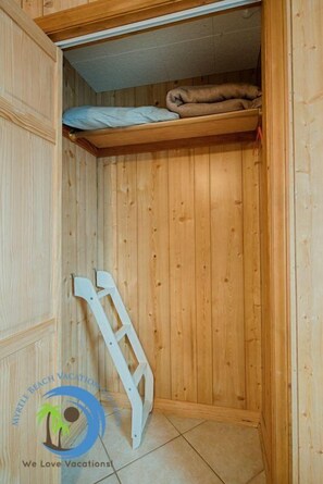 Cozy retreat with a ladder and a comfortable reading nook.