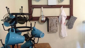 A kitchen with a utensil rack holding various kitchen tools and cookware. - Half-timbered house Dorothea up to 4 people (Stuer)