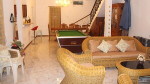 A living room with a pool table, wicker furniture, a staircase, and a chandelier. - Private villa for families, with private pool and beautifully furnished (Pereybere)