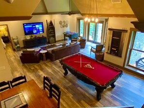 A spacious living area with a pool table, comfortable seating, a television, and a fireplace. - Cabin, hot tub, High Speed Internet, fire pit, resort, hiking, boating,spa,golf (Lake Lure)