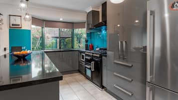 Enjoy cooking in this well-equipped kitchen with a large island, gas stove, and window offering a view of the outdoors.