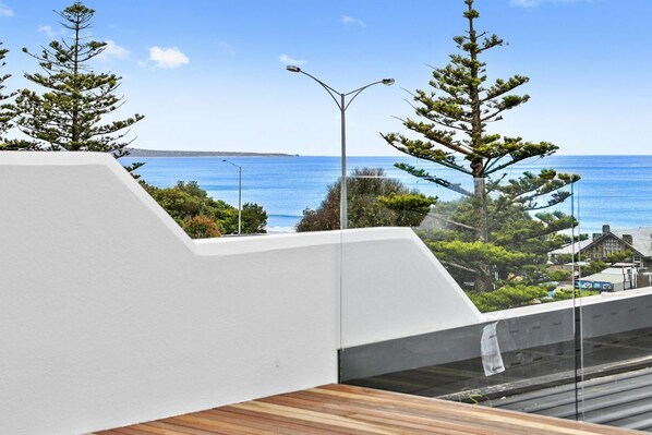 A modern building with a view of the sea, a street lamp, and a sign for 'Lorny's Pavilion.'