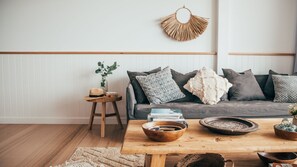 Relax in this inviting living space with a comfortable sofa, coffee table, and natural touches.