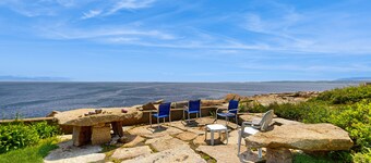 Sweeping, dog-friendly, waterfront home w/ a sun room, ocean views, & fireplaces