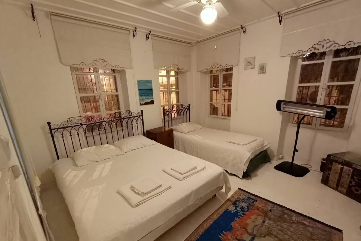 Triple Room, Shared Bathroom | Desk, laptop workspace, blackout drapes, iron/ironing board