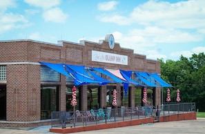 A brick building with a sign reading "Line Star GLAMP INN." - Lone Star Glamp Inn (Round Top)