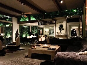 Un salon moderne comprenant un canapé, une table basse et un coin repas avec des chaises et une table.