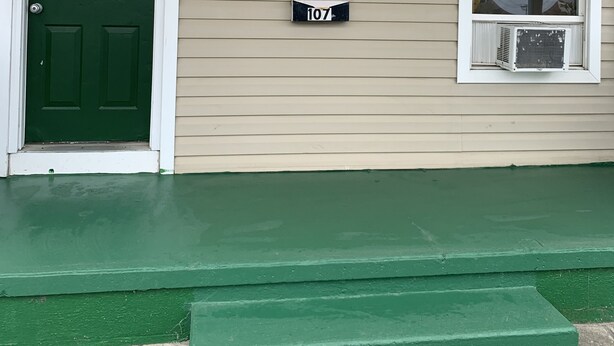 Une maison avec une porte verte et une plaque indiquant « WILMINGTON TERRACE 107 ».