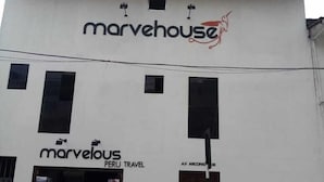 A building with the 'marvehouse' sign and 'marvelous Peru Travel' below it. - Marvelous Plaza (Cusco)