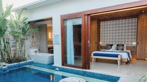 A modern hotel room with a private pool, a spa area, and a bedroom with a large bed and a wooden headboard. -  The Mavila Sanur (Denpasar)