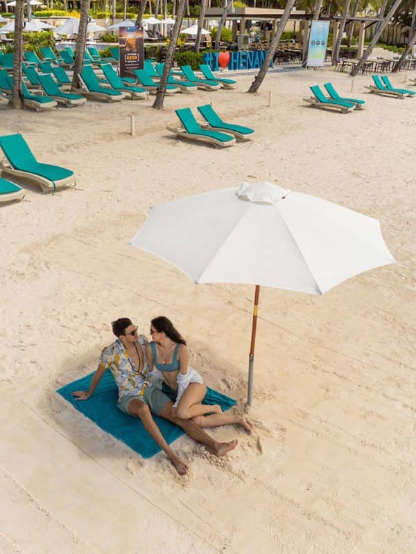 On the beach, white sand, sun loungers, beach umbrellas