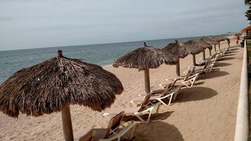 On the beach, sun loungers, beach towels