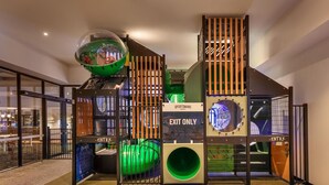 A play structure with a green slide and a ball pit, labeled "SPORTSMANS" and "EXIT ONLY". - Blacktown Tavern (Blacktown)