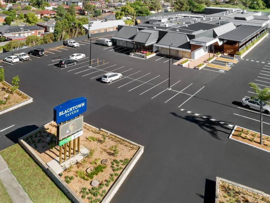 A parking lot with a sign for Blacktown Tavern and a VIP Lounge.