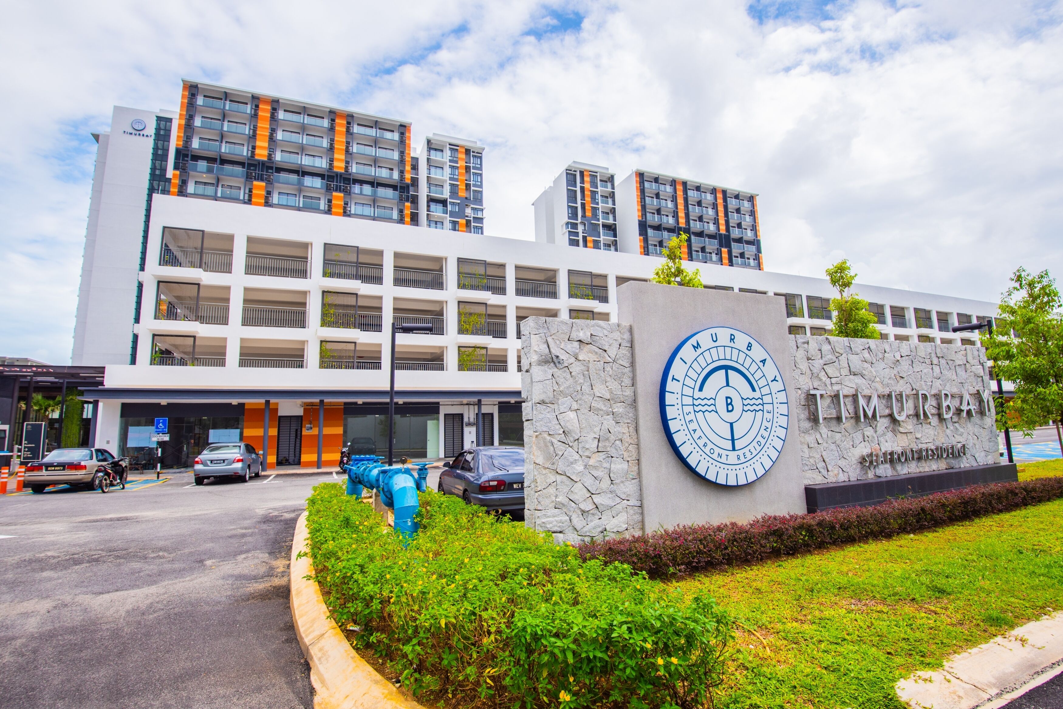 A modern building with a sign reading "Tim MURBAY" and "SEAFOOD RESIDENCE".