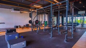A gym with weightlifting equipment, treadmills, and weight plates.