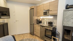 A compact kitchen with modern appliances, a built-in oven, and a microwave.