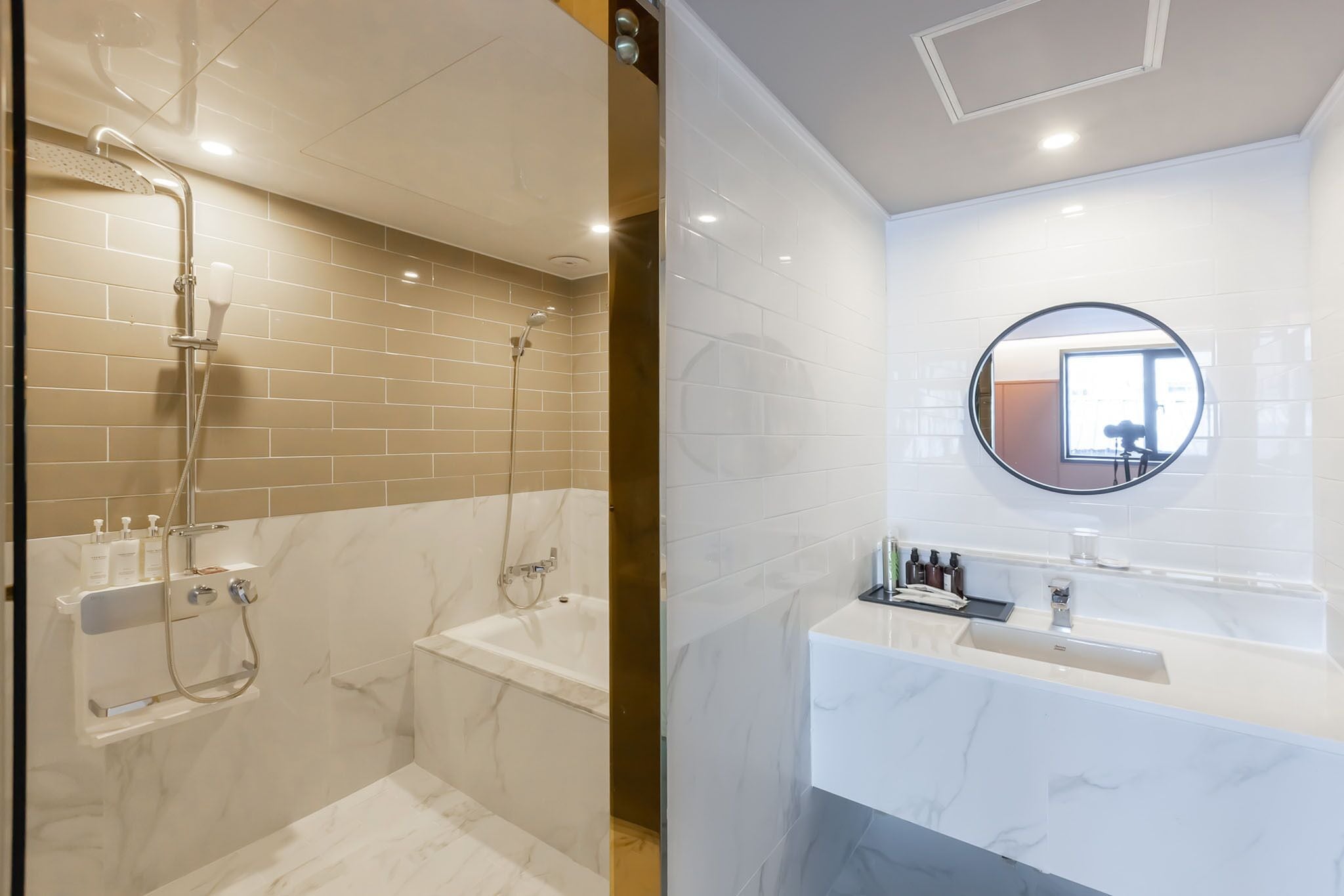 A modern bathroom with a shower, bathtub, and a vanity with a mirror.