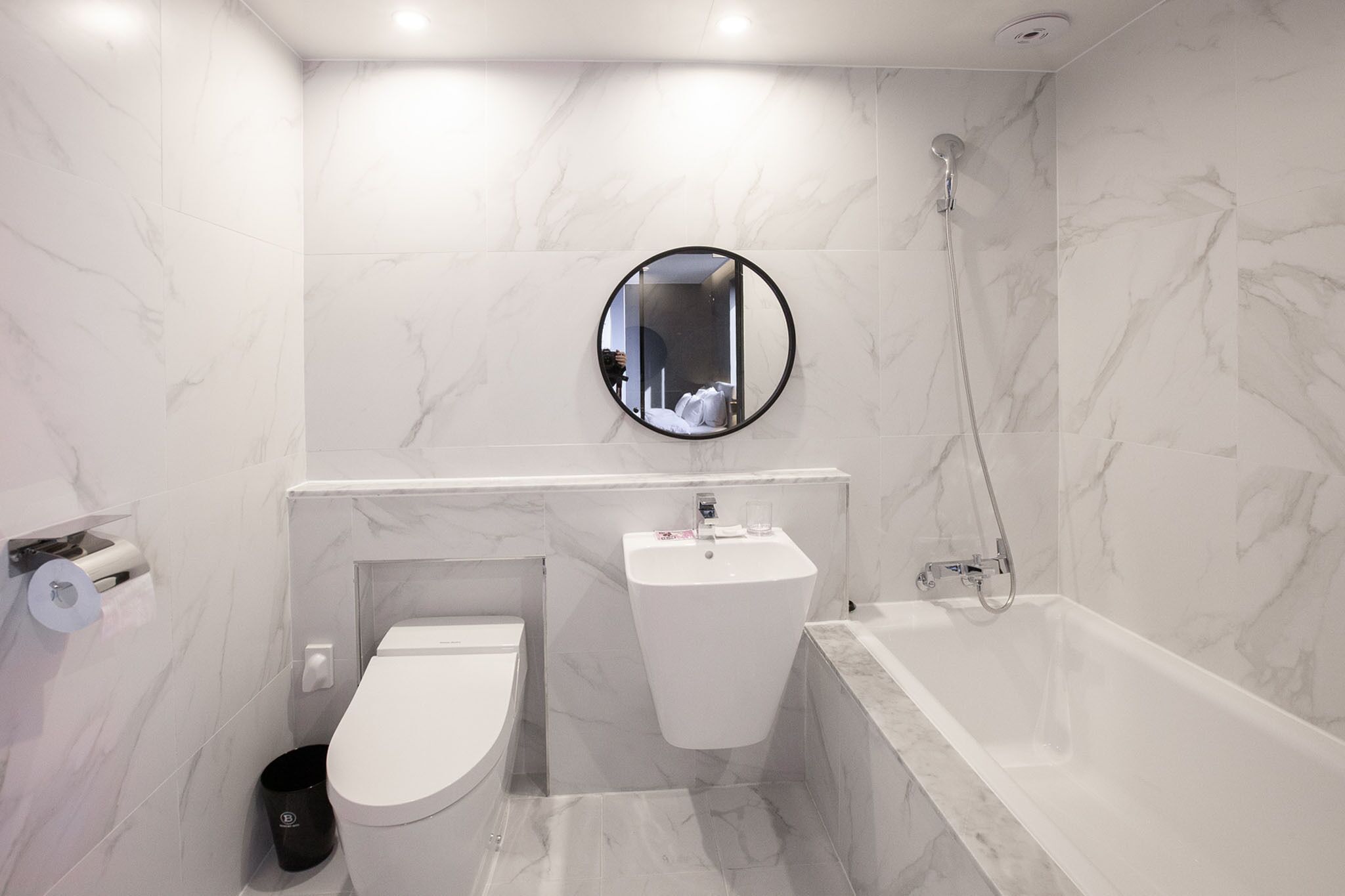 Un baño moderno con inodoro, lavamanos y bañera.