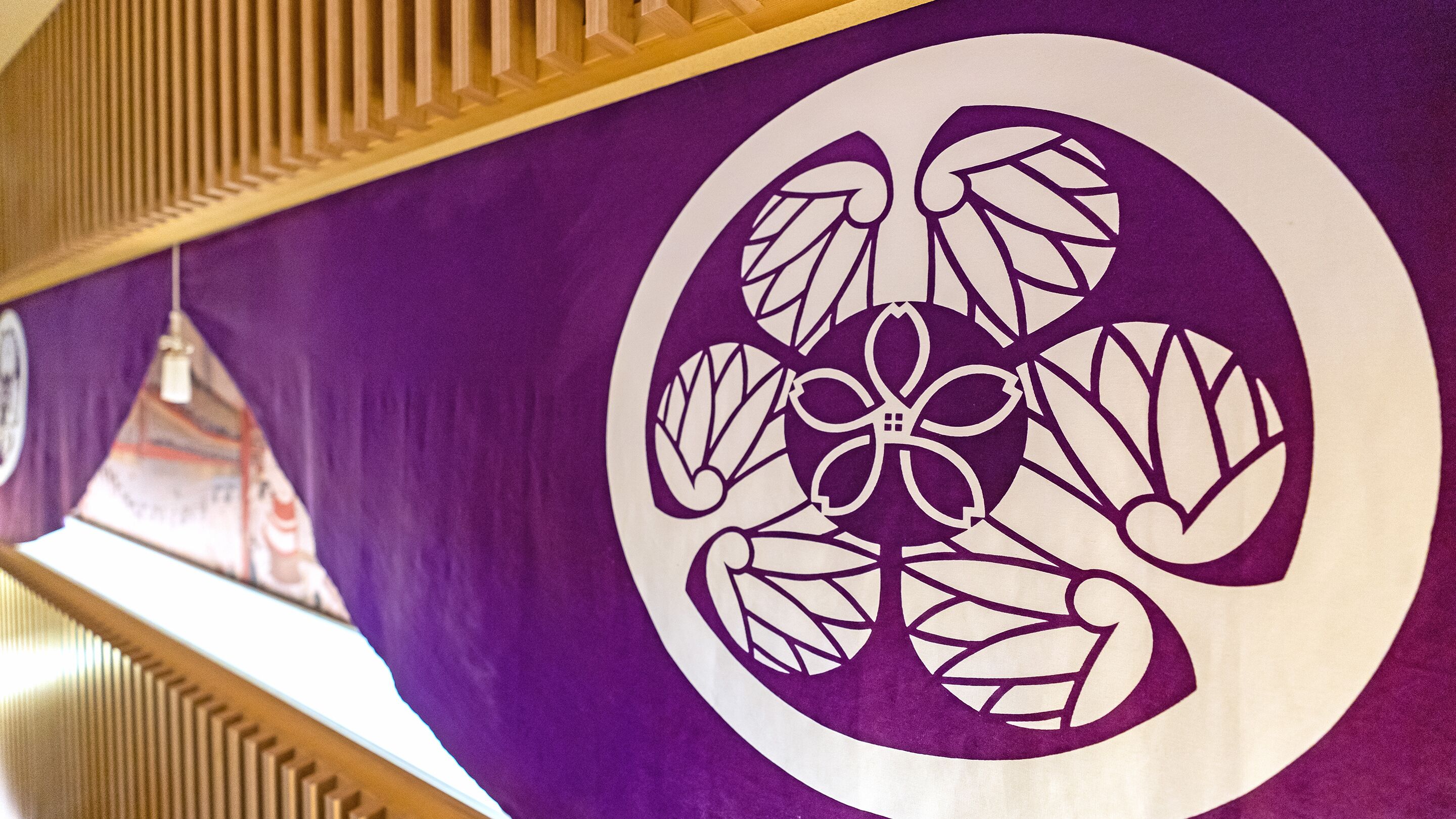 A purple wall with a white circular design.