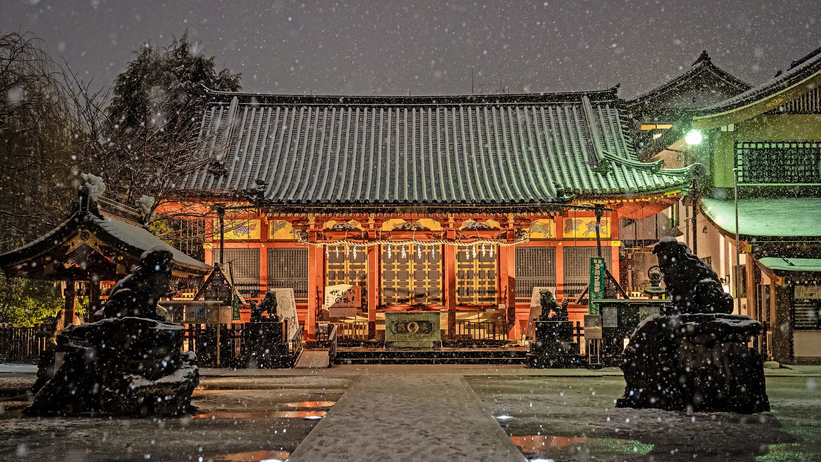 A traditional building with a tiled roof and a central entrance.