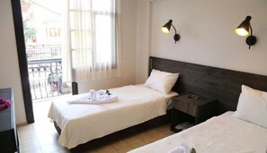A hotel room with two beds, a wooden headboard, a nightstand, and a window with curtains. - Derin Luxury Hotel (Kemer)