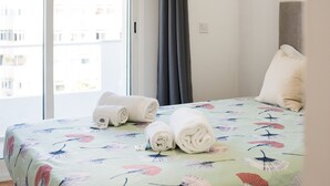 Une chambre d’hôtel avec un lit, une fenêtre et une vue sur les bâtiments environnants.