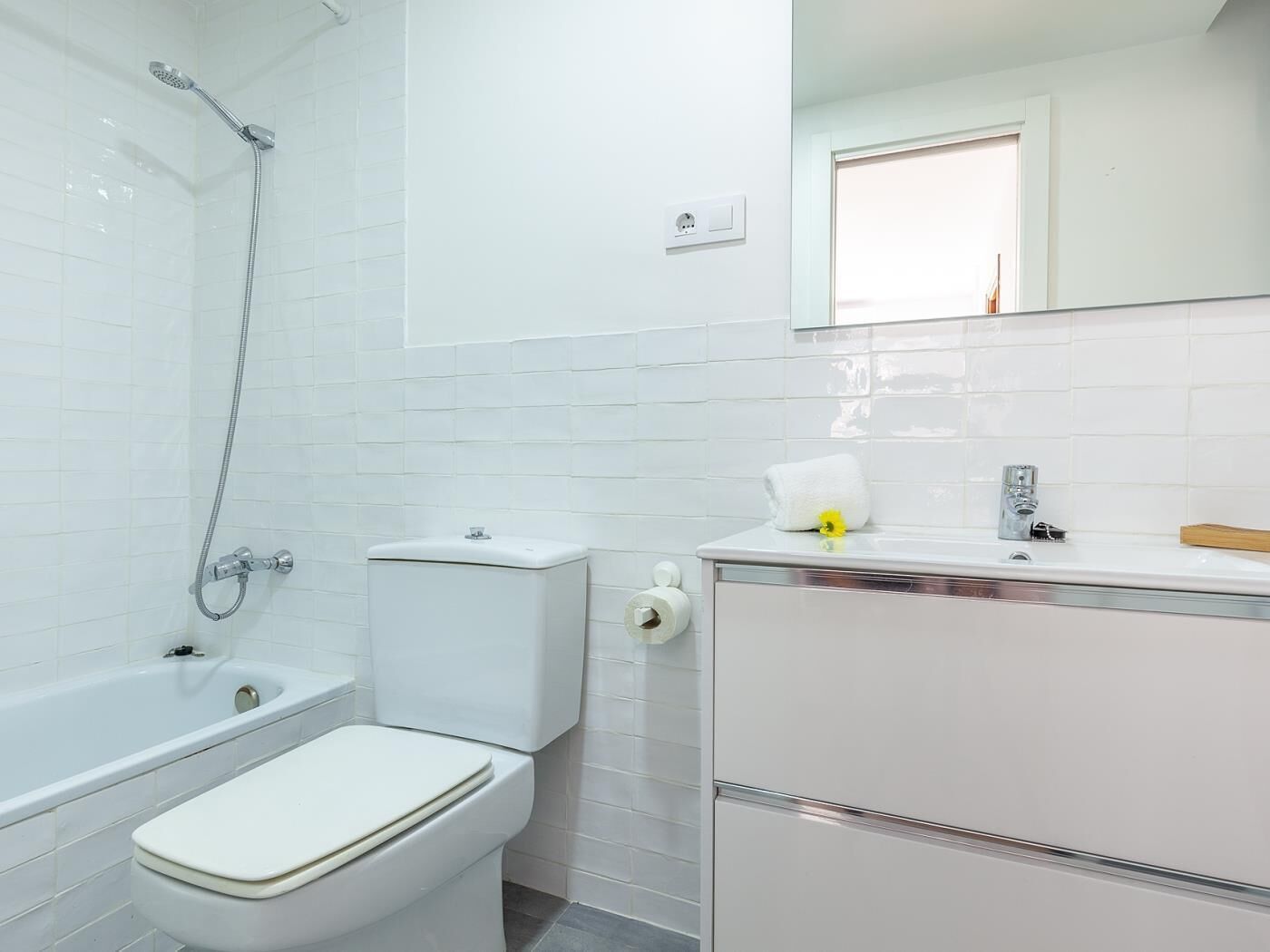 A bathroom with a bathtub, toilet, and sink.
