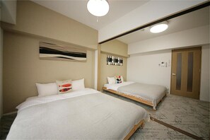 A hotel room with two beds, a large mirror, and a door. - goom Hotel Fukuoka-Tenjin (Fukuoka)