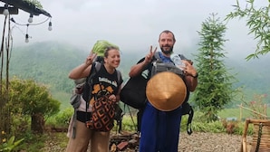 Two people standing on a rocky path with a mountainous landscape in the background. - The Little H'mong House (Ta Van)