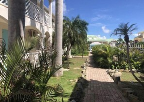 Stroll through the serene courtyard surrounded by lush greenery and arched windows.