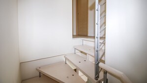 A staircase with a handrail and a mirror on the wall. - Tasso (Ferrara)