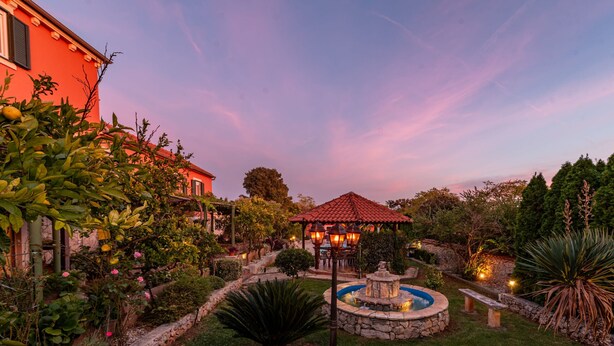 A garden with a gazebo, a fountain, and a stone wall. - Villa Stocco ZadarVillas (Ugljan)