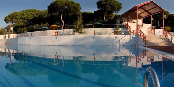 Seasonal outdoor pool, open noon to 8:00 PM, pool umbrellas