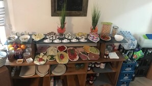 A buffet table with various food items and condiments.