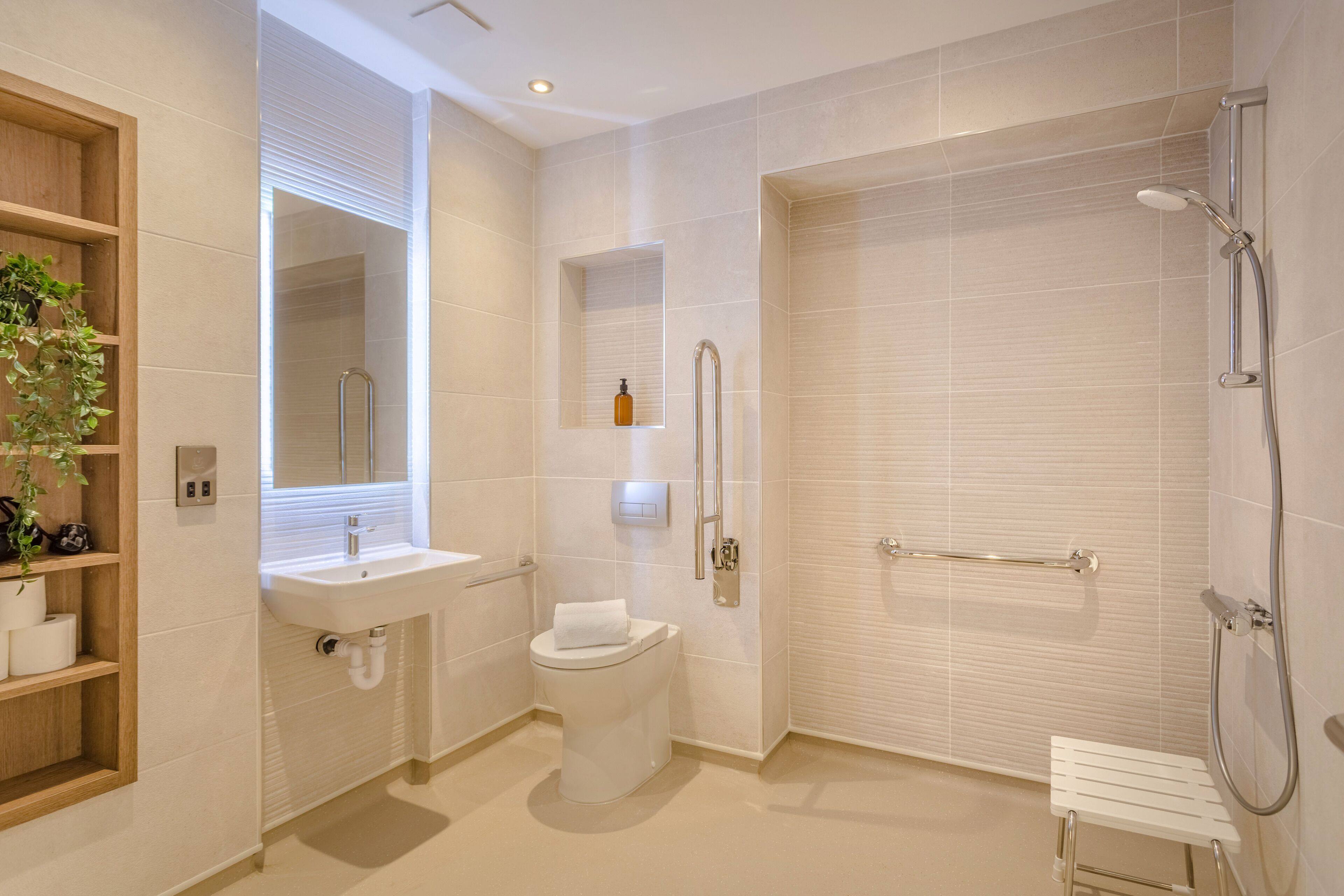 A modern bathroom with a toilet, sink, and shower.