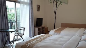 A hotel room with a bed, a desk, a chair, a television, and a window with curtains. - Maple Farm (Guangfu)