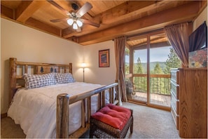 Downstairs Queen Bedroom with glass slider to back deck.