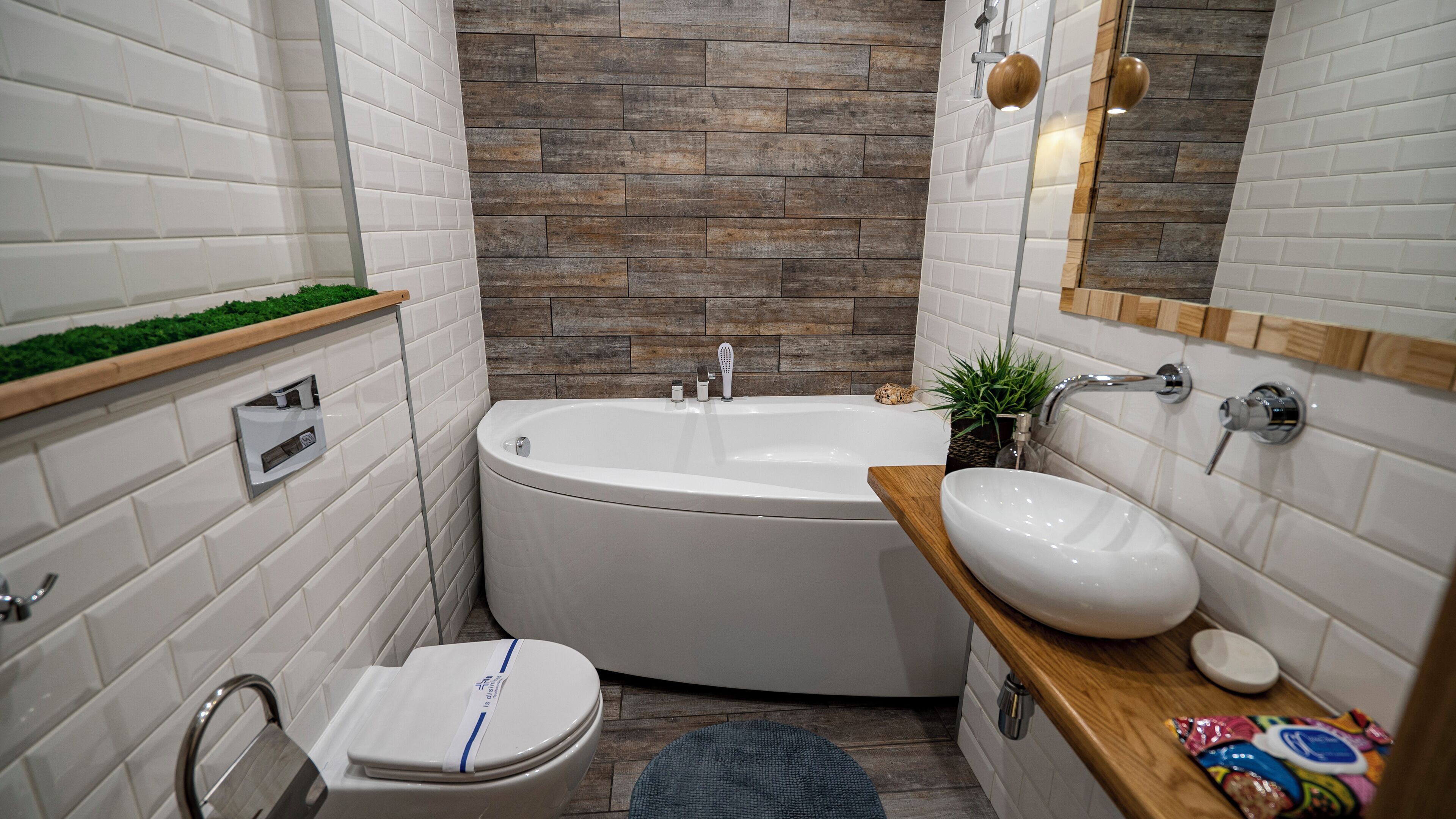 A modern bathroom with a freestanding bathtub, a toilet, and a sink.
