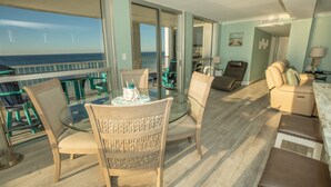 A balcony with a glass table and chairs, a sofa, and a view of the ocean. - 2106 is a Gulf Front 3 bedroom unobstructed views by RedAwning (Destin)