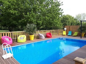 Seasonal outdoor pool, a heated pool, pool umbrellas, pool loungers