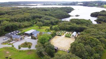 A rural property with a large barn, a stable, and a fenced paddock.