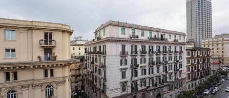 A multi-story building with a classical architectural style, featuring a central courtyard and multiple balconies.
